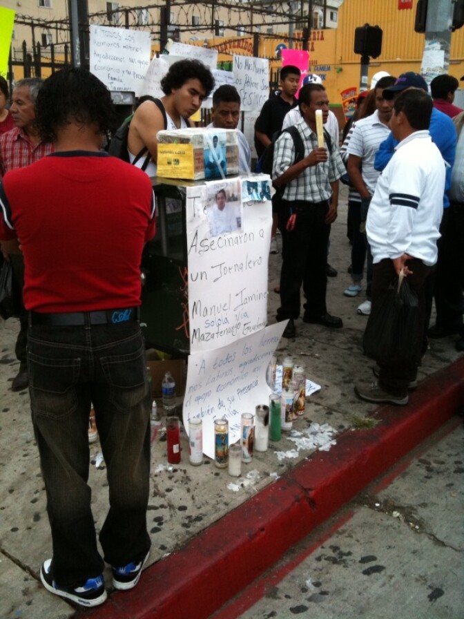 People gather at the memorial for Manuel Jamines, a Guatemalan immigrant who was shot and killed by an LAPD officer at Sixth Street and Union. The shooting has prompted angry protests.