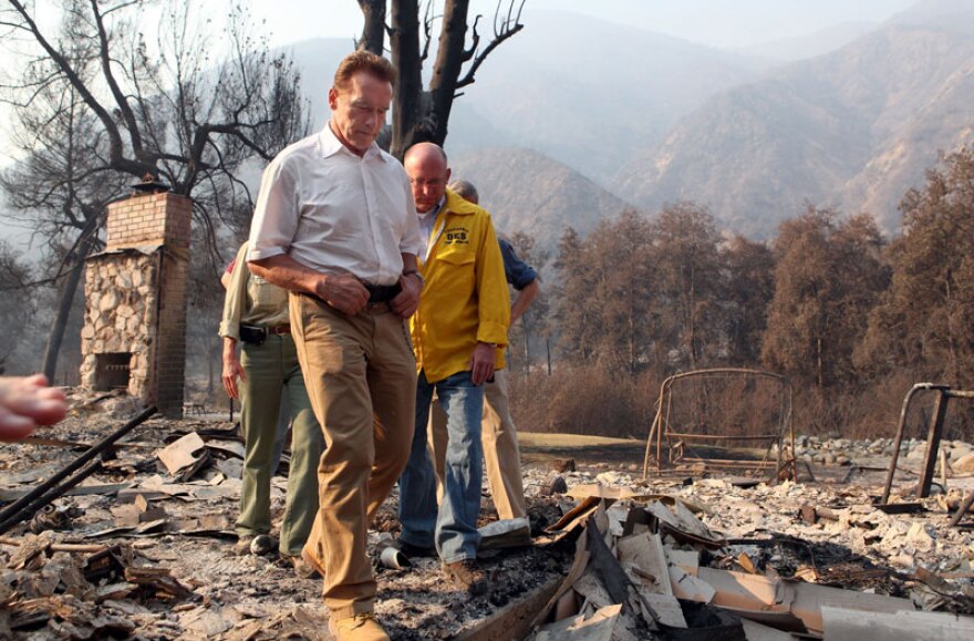 California Gov. Arnold Schwarzenegger (L) and Acting Secretary of Cal E.M.A. Matt Bettenhausen walk through rubble as they tour homes that were burned by the Station Fire September 2, 2009 at Vogel Flats near Tujunga, California. Fire officials said that the deadly 140,000 acre Station Fire was human caused. The fire, now 22 percent contained, has destroyed over 70 structures and has forced thousands of evacuations as several thousand homes are continue to be threatened. Two firefighters were also killed on Sunday trying to save an inmate fire-crew camp on Mount Gleason.