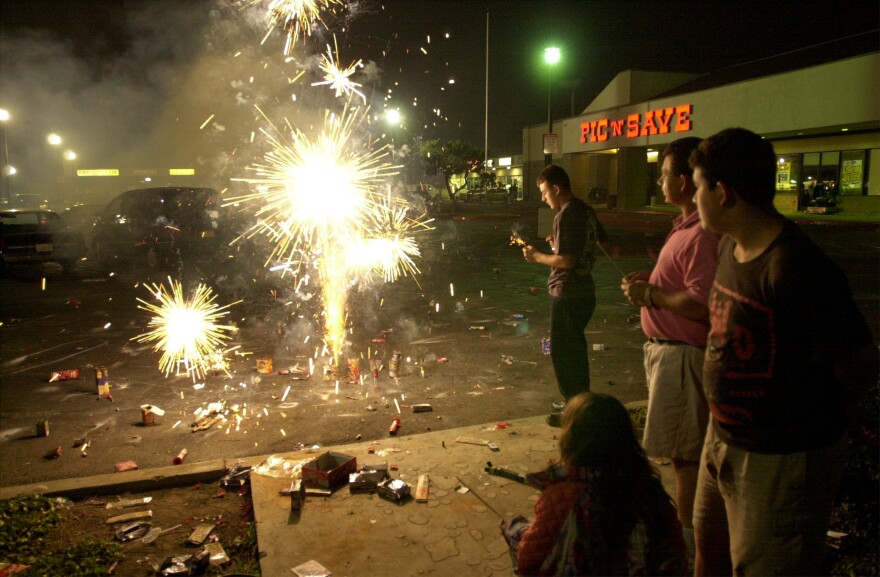 File: A family lights fireworks to celebrate the Fourth of July, 2000, in Santa Ana, where personal fireworks are legal.