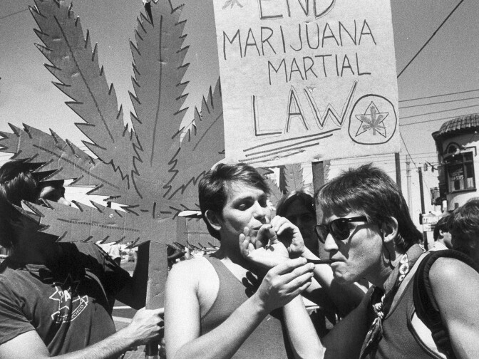 Two protesters take a drag on each other's marijuana joints during a "taste-in" sponsored by the Northern California Marijuana Growers in San Francisco, July 13, 1984. The growers' association is organizing Saturday's rally and parade in San Francisco to protest for the legalization of marijuana.  