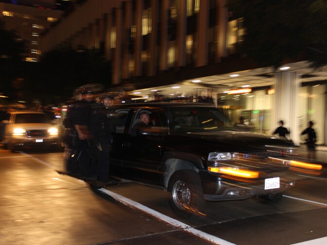 LAPD officers in riot gear at site of mass arrests.
