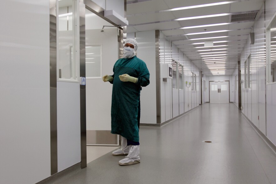 MIAMI, FL - SEPTEMBER 20:  Elkin Vasquez, Operation manager for University of Miami Tissue Bank, walks through the halls of the laboratories during the grand opening of the University of Miami Life Science & Technology Park on September 20, 2011 in Miami, Florida. The building opened this week and is expected to employ more than 1,000 people in the biotech industry.  (Photo by Joe Raedle/Getty Images)