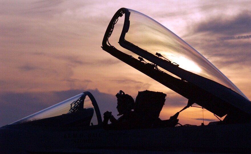 USS CONSTELLATION - JANUARY 15:  A U.S. Navy flight crewman works in the cockpit of a U.S. Navy F/A-18 Hornet after returning to base aboard the USS Constellation January 15, 2003 which is currently in the Persian Gulf area. The Hornets are flying patrol missions in the Iraqi southern no-fly zone in support of Operation Southern Watch.   (Photo by Scott Nelson/Getty Images)