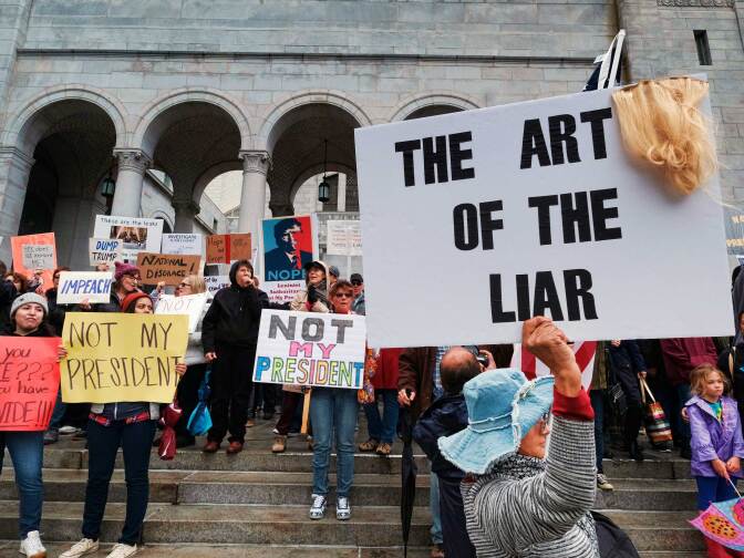 Protesters stand on the steps of Los Angeles City Hall on Monday, Feb. 20, 2017. Demonstrators gathered to express their opposition to President Donald Trump and take part in a "Not My President's Day" rally. 