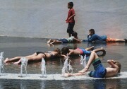 Children try to cool down and take advantage of the Grand Park fountain in downtown Los Angeles on Wednesday, July 5, 2017. Forecasters say a new heat wave is setting in across the interior of Southern California, and the southern Sierra Nevada is facing a period of elevated fire danger. The National Weather Service says the heat is coming from high pressure building over the desert Southwest that will expand westward. (AP Photo/Richard Vogel)