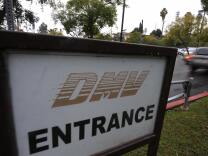 A car arrives at the State of California Department of Motor Vehicles (DMV) in Los Angeles, California on February 13, 2009.   The DMV, already infamous for long waiting times, is now further taxed as employees are off the job and the offices are closed two days a month as California government imposes its first-ever unpaid furlough to save money during the fiscal crisis.  The action is in connection with Schwarzenegger’s executive order that addresses the state’s 42 billion USD deficit and ongoing fiscal crisis.  Schwarzenegger has also threatened to lay off as many as 10,000 state employees if a new budget is not passed this week.  AFP PHOTO/ ROBYN BECK (Photo credit should read ROBYN BECK/AFP/Getty Images)