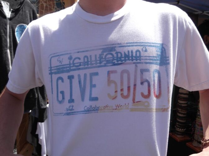 A T-shirt by Collaborative World stating their goal of giving away 50% of their profits to nonprofits.