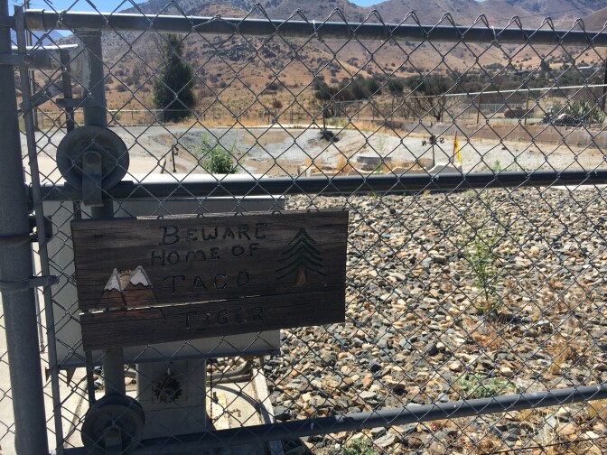 This chain link fence and a sign warning visitors to beware pets named "Taco and Tiger" is what little remains after the Erskine Fire burned hundreds of mobile homes in South Lake near Lake Isabella.