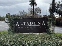  A black sign with white text reads “Altadena Town & Country Club, est. 1910.”

