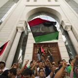 Tunisians and Libyans living in Tunisia wave Libya's National Transitional Council flags as they celebrate on October 20, 2011 in the Mohamed V street of Tunis after the announcement of the death of Libyan strongman Moamer Kadhafi. Kadhafi who was killed when his hometown Sirte fell after refusing to surrender, ruled his North African country for 42 years before being ousted in August. AFP PHOTO / LIONEL BONAVENTURE (Photo credit should read LIONEL BONAVENTURE/AFP/Getty Images)