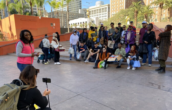 Some two dozen people pose for a group photo at Pershing Square. 