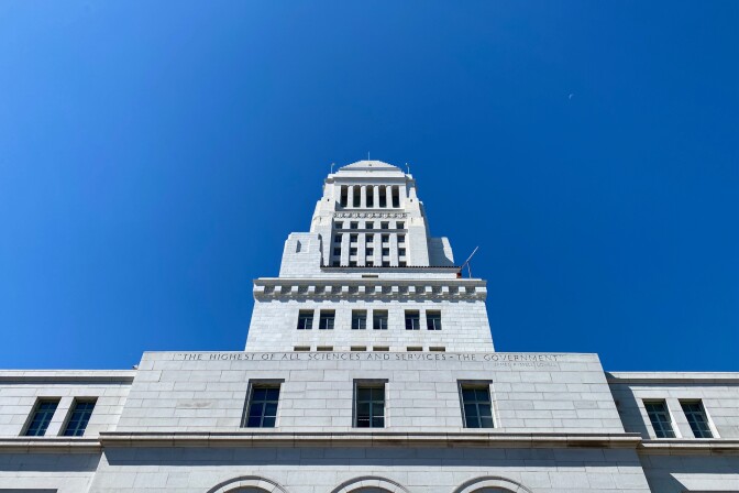 City Hall against a blue sky from the perspective of someone looking up.