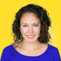 Portrait of Ariel Zirulnick, smiling, against a yellow background.
