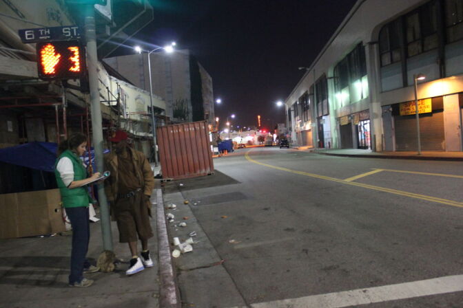 Annabelle Rosborough, 28, surveys Edward Potts, a homeless man who lives on Skid Row during the homeless count in Downtown Los Angeles on January 30, 2013.