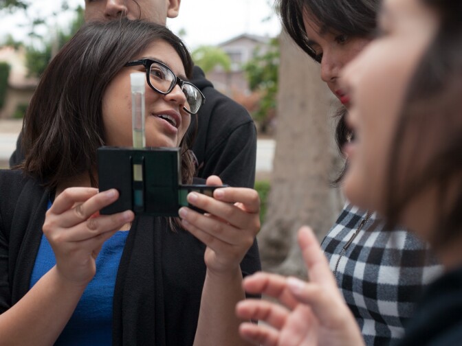 Natalie Martinez and her classmates conduct a stream study bio-assessment of the Greenville Banning Channel near their school, Godinez Fundamental High School in Santa Ana, on Wednesday, May 13, 2015. 