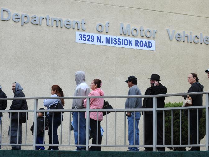 File: People wait in line outside of the State of California Department of Motor Vehicles (DMV) in Los Angeles, California on February 13, 2009.   