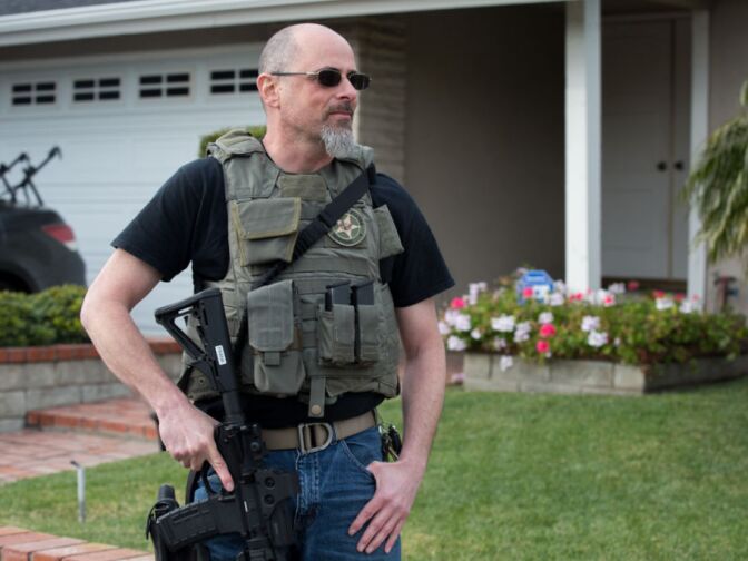 A U.S. Marshall waits outside of Christopher Jordan Dorner's residence in La Palma, Calif. on February 8th, 2013.