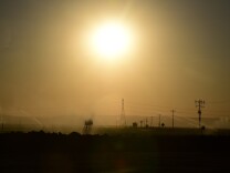 File: Crops in the distance are watered beneath the sweltering sun on March 29, 2015 in Kern County, California, which became the nation's number 2 crop county for the first time in 2013, near where the West branch of the California Aqueduct begins its ascent to Castaic and Pyramid Lakes in the Angeles National Forest, supplying water to the populations of the Los Angeles basin. The snowpack in the Sierra Nevada mountain range hit an unprecedented low this week, falling below historic lows of 2014 and 1977 for the state's driest winter in sixty-five years of record keeping. California's drought, now in its fourth year, is going from bad to worse.