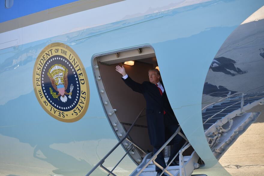 US President Donald Trump waves as he boards Air Force One before departing from Andrews Air Force Base in Maryland on March 13, 2018. 
Trump is heading to California where he is expected to inspect the border wall prototypes in San Diego. / AFP PHOTO / MANDEL NGAN        (Photo credit should read MANDEL NGAN/AFP/Getty Images)