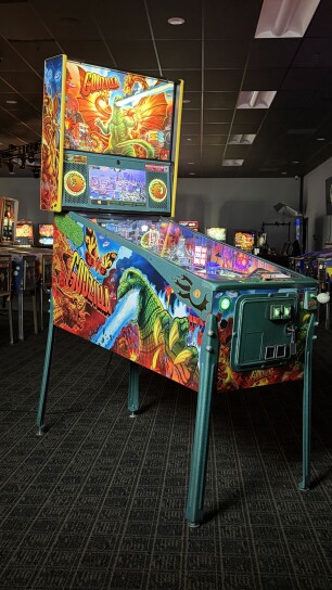 A pinball machine centered among others. 