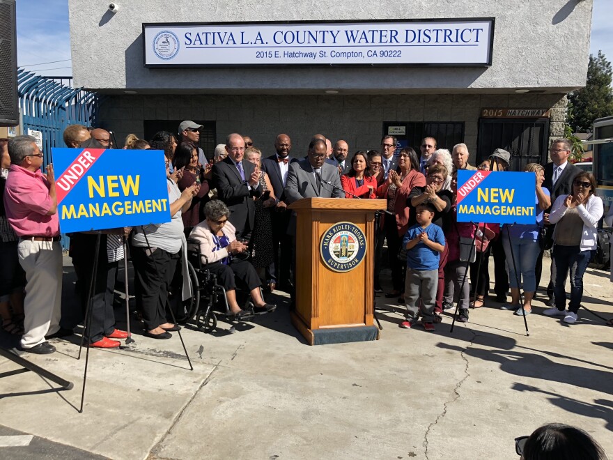 Government officials and local residents flank LA County Supervisor Mark Ridley-Thomas as he announces the county's take over of Sativa Water District.