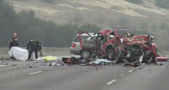 Investigators at the scene of a wrong-way wreck on the 60 Freeway that killed six people on Feb.  9, 2014.
