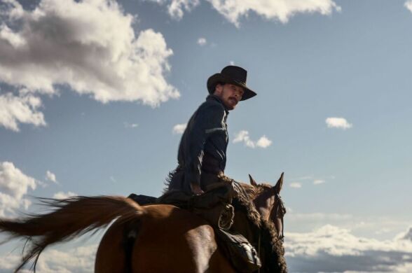 Actor Benedict Cumberbatch on horseback and wearing a black cowboy hat.