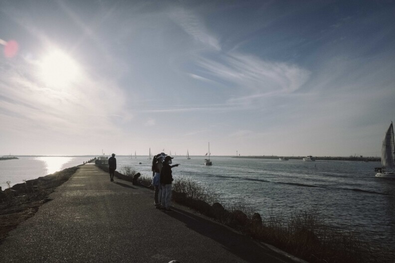 Families watch boats sail by at the end of the Park to Playa trail.