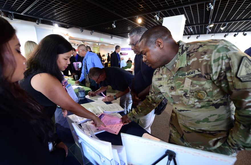 US Army Sergeant Kierre Tate (R) inquires about employment prospects at the first Los Angeles International Airport (LAX) Job Fair for Veterans in Los Angeles, California on September 14, 2016, where more than 20 airport employers were on hand with airport officials to support local veterans in seeking employment.  / AFP / Frederic J. BROWN        (Photo credit should read FREDERIC J. BROWN/AFP/Getty Images)