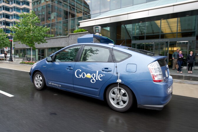 Caption:The Google self-driving car maneuvers through the streets of in Washington, DC May 14, 2012. The system on a modified Toyota Prius combines information gathered from Google Street View with artificial intelligence software that combines input from video cameras inside the car, a LIDAR sensor on top of the vehicle, radar sensors on the front of the vehicle and a position sensor attached to one of the rear wheels that helps locate the car's position on the map. As of 2010, Google has tested several vehicles equipped with the system, driving 1,609 kilometres (1,000 mi) without any human intervention, in addition to 225,308 kilometres (140,000 mi) with occasional human intervention. Google expects that the increased accuracy of its automated driving system could help reduce the number of traffic-related injuries and deaths, while using energy and space on roadways more efficiently. AFP PHOTO/Karen BLEIER (Photo credit should read KAREN BLEIER/AFP/GettyImages)
