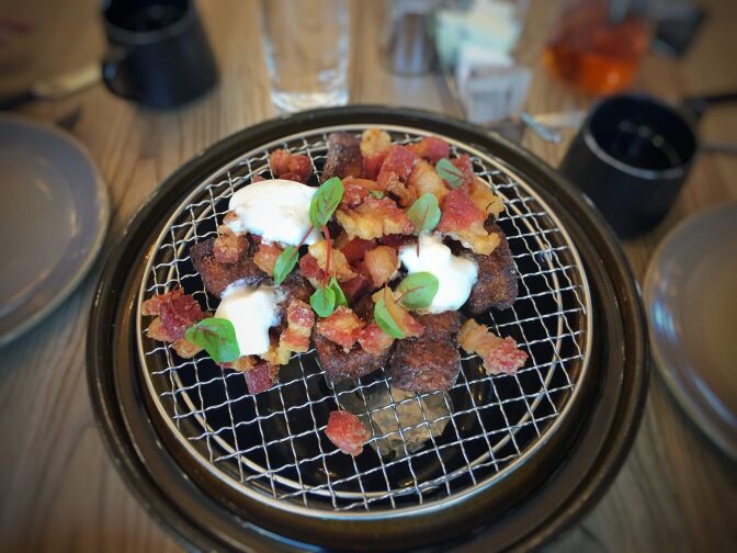 French toast, lardons, maple cream, truffle butter, and jam served on a nabe pot at Otium in Downtown Los Angeles