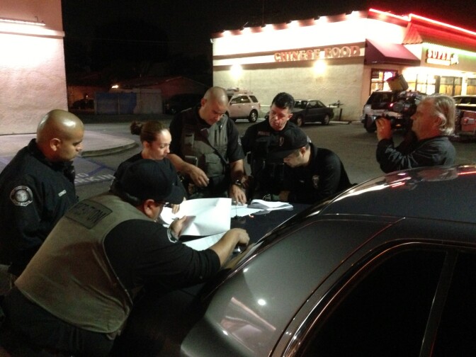 A cameraperson shoots footage for a local TV news segment featuring L.A. County's Probation department and its high-profile "absconders."