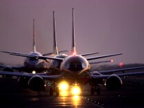 File: Jets taxi after sunset June 21, 2001 at Los Angeles International Airport. 