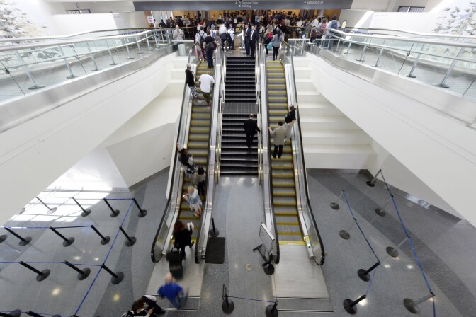 Travelers approach the security screening after Terminal 3 was re-opened a day after a shooting at Los Angeles International Airport November 2, 2013 in Los Angeles, California. The airport is almost back to normal operations 2 days after a man pulled out an assault rifle and shot his way through security at Terminal 3, killing one Transportation Security Administration worker and wounding several others. Federal officials identified the alleged gunman as Paul Ciancia, 23.  