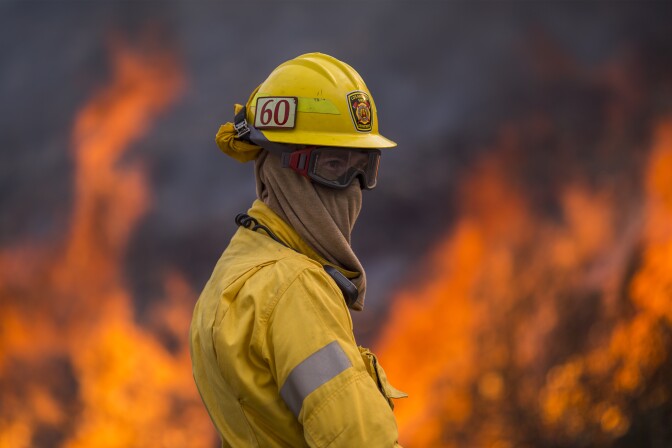 BURBANK, CA - SEPTEMBER 02: Flames rise behind a firefighter at the La Tune Fire on September 2, 2017 near Burbank, California. Los Angeles Mayor Eric Garcetti said at a news conference that officials believe the fire, which is at 5,000 acres and growing, is the largest fire ever in L.A. People have been evacuated from hundreds of homes in Sun Valley, Burbank and Glendale. About 100 Los Angles firefighters are expected to return soon from Texas, where they've been helping survivors from Hurricane Harvey.    (Photo by David McNew/Getty Images)