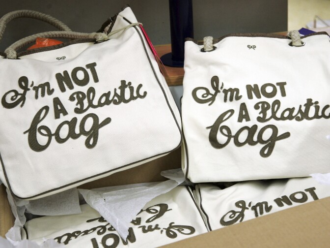 LONDON - APRIL 25:  Anya Hindmarch's bags "I'm Not A Plastic Bag" await customers at the Sainsbury's store in Camden on April 25, 2007 in London. The limited edition bags have been seen on the arms of A-List stars such as Keira Knightley, Lily Cole, Scarlett Johansson, and Jessica Alba. Customers queued since the early hours to get their hands on the  GBP 5.00 bags as each store had limited quantities.  (Photo by Gareth Cattermole/Getty Images)