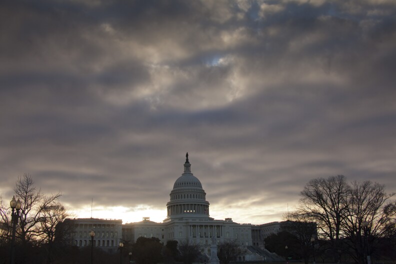 At dawn, the sun breaks through dark clouds over Capitol Hill in Washington, Thursday, March 7, 2013. (AP Photo/J. Scott Applewhite)