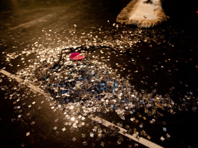 Property master Scott Thomas sweeps up fairy dust off the stage into a pile.