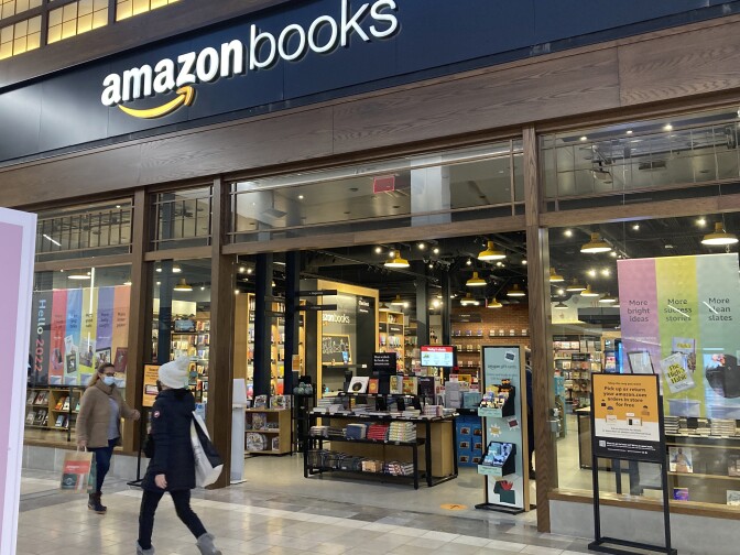 People walk by an Amazon Books store at the Westfield Garden State Plaza shopping mall in Paramus, N.J., on Jan. 10, 2022.