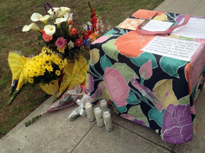 Students and neighbors brought flowers to the house throughout the day where two USC graduate students were shot and killed, April 11, 2012.