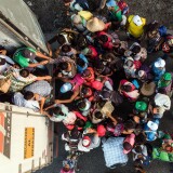 TOPSHOT - Honduran migrants taking part in a caravan heading to the US, get on a truck, near Pijijiapan, southern Mexico on October 26, 2018. - The Pentagon is expected to deploy about 800 troops to the US-Mexico border, two US officials told AFP on Thursday, after President Donald Trump said the military would help tackle a "national emergency" and called on a caravan of US-bound migrants to turn around. (Photo by Guillermo Arias / AFP)        (Photo credit should read GUILLERMO ARIAS/AFP/Getty Images)