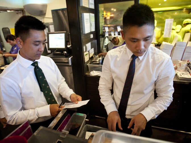 Albert and Aaron Yang, sons of Frank Yang, help out at the Arcadia dumpling house.