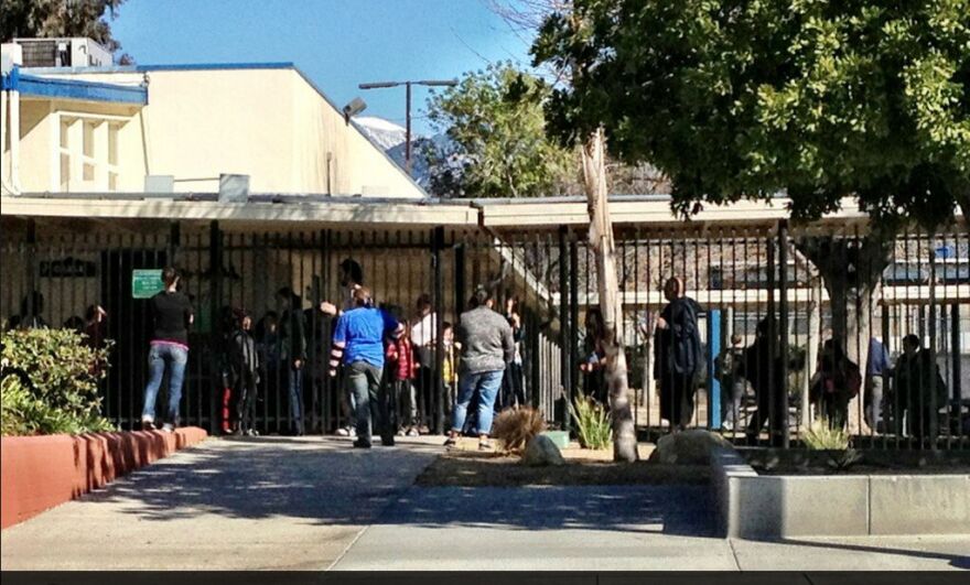 This is a photo from Thomas R. Cordova, who describes himself as a staff photographer at the Inland Valley Daily Bulletin, showing parents picking up their children after schools in the Big Bear area were locked down on Feb. 12, 2013. Police enegaged in fire gun battles in the area with someone they believe to be Christopher Dorner.