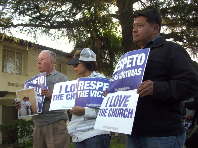 Protesters hold signs as Catholics United delivers a petition asking Cardinal Roger Mahony not to attend the papal conclave, Saturday, Feb. 23, 2013.