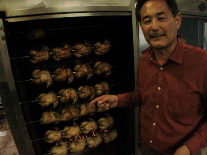 Juan Pollo owner Albert Okura shows of the kitchen, and some chickens, at his flagship restaurant near downtown San Bernardino. 


