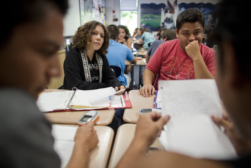 El Dorado high school students Jose Bobadilla (foreground left), Elysia Arroyo and Moises Castro listen to Christyan Garcia read a poem in Sunshine Cavalluzzi's social science class at El Dorado High School in Placentia.