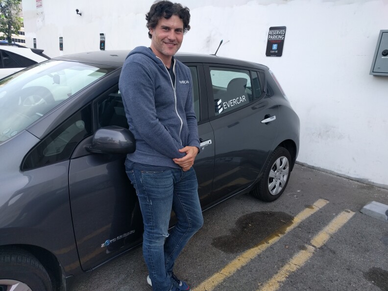 EverCar founder Michael Brylawski stands next to one of the Nissan Leafs available through the service. Cars can be rented specifically to drive for an Uber or Lyft shift through EverCar.