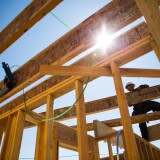 Walter Cruz works on a new home in Mountain House, California. As a master-planned community, Mountain House has a mountain of debt that they can only service by building more homes – despite their uncertainty of their water supply.
