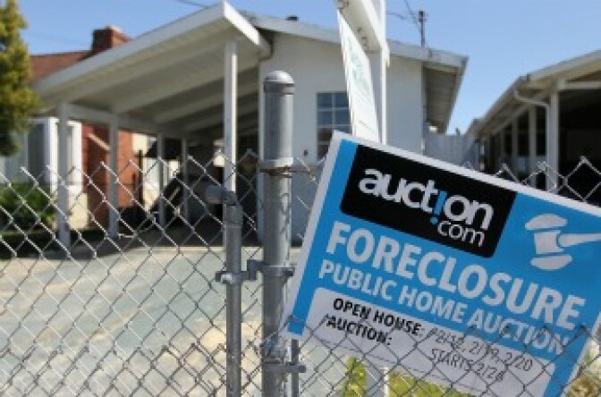 A foreclosure sign hangs on a fence in front of a foreclosed home on April 6, 2011 in Richmond, California. 