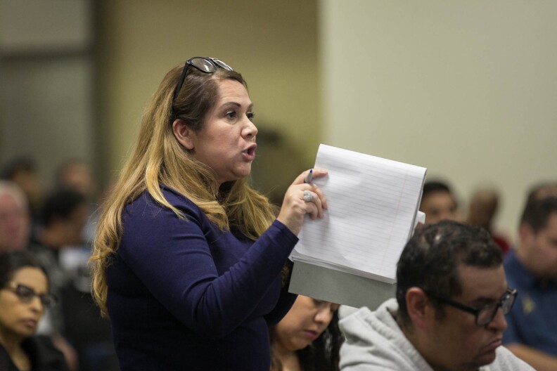Paramount resident Laurie Guillen speaks at a a town hall meeting at the Paramount Community Center hosted by South Coast Air Quality Management District (SCAQMD) and Los Angeles County Department of Public Health to provide the public with information on air monitoring efforts and the investigation of hexavalent chromium sources on Monday, Dec. 12, 2016 in Paramount, Calif.